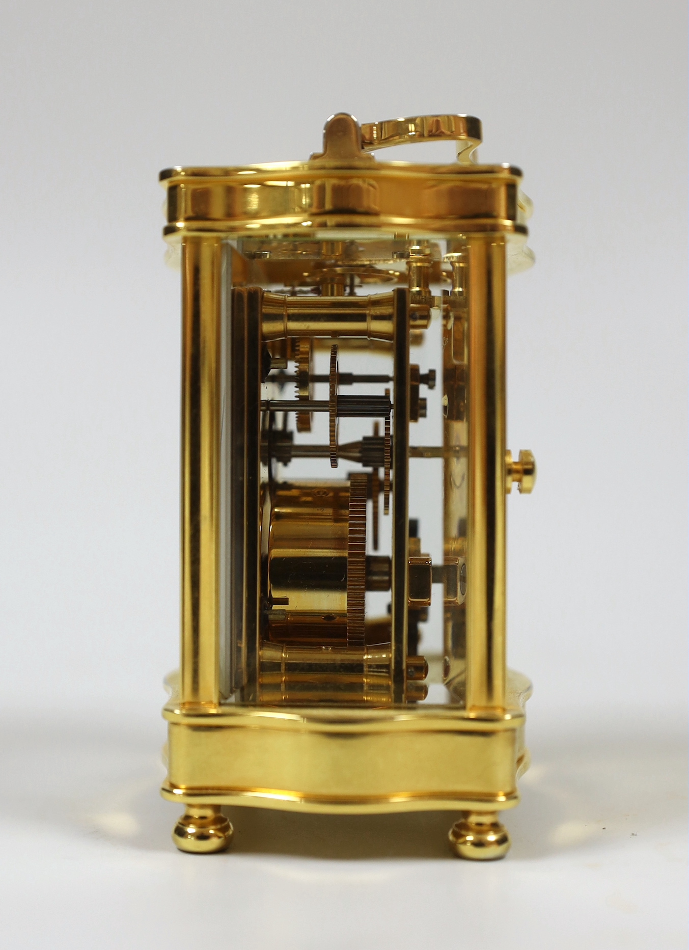 A French miniature brass cased serpentine fronted eight day carriage timepiece by L’Epee, 9cm high